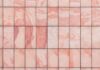 a close up of a pink marble tile wall