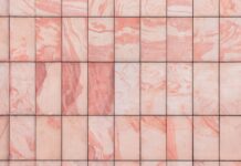 Réussir la pose de carrelage sans joint pour un sol parfait a close up of a pink marble tile wall