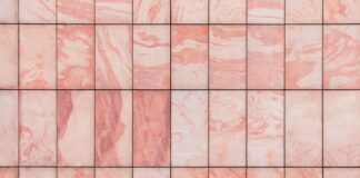 a close up of a pink marble tile wall